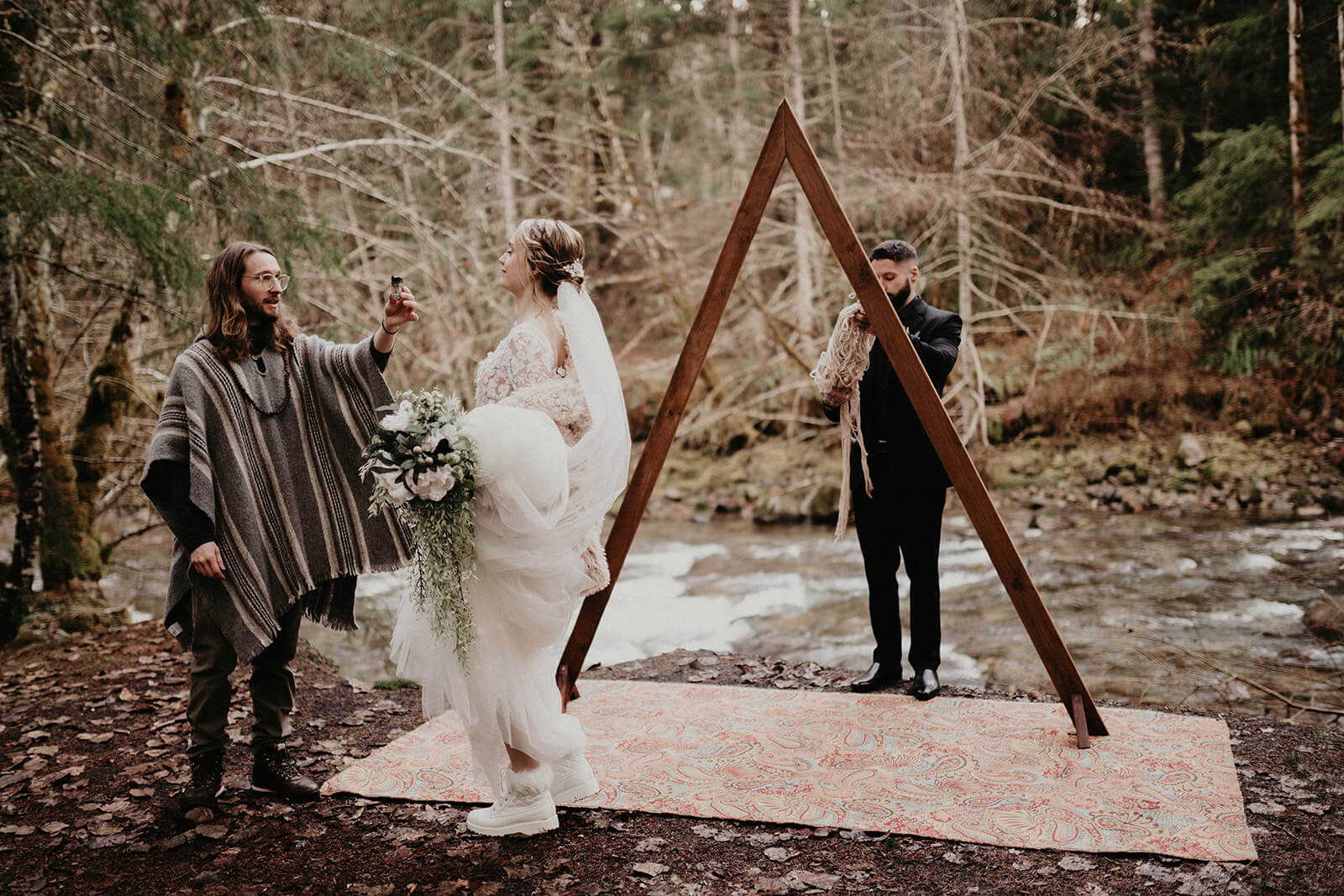 Bride, groom and officiant setting up and saging ceremony site  