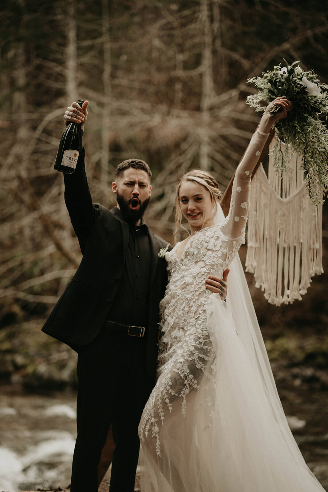 Bride and groom cheering after elopement ceremony at Mt Rainier