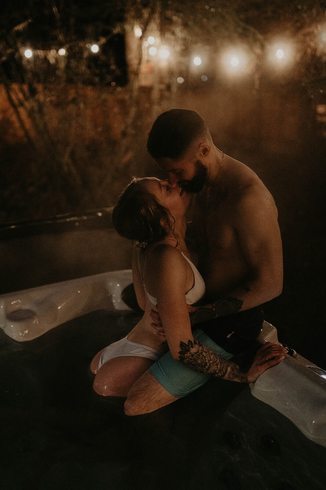 Bride and groom kissing in the hot tub at cozy cabin in Mount Rainier