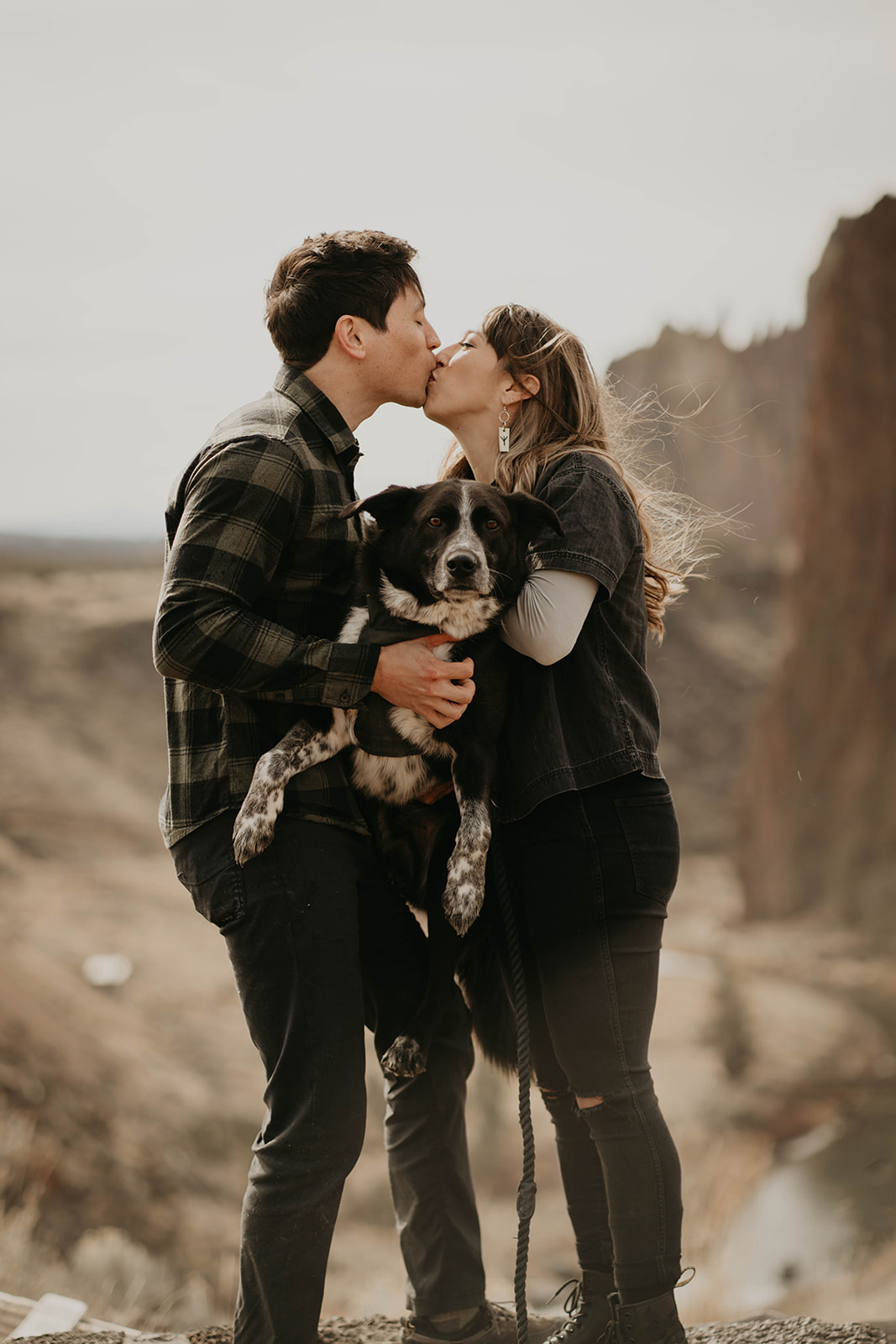 Couple kissing at rock climbing engagement session