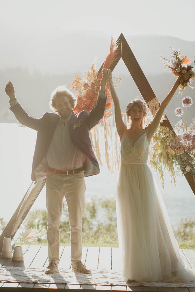 Bride and groom cheer after wedding ceremony on Thunder Island