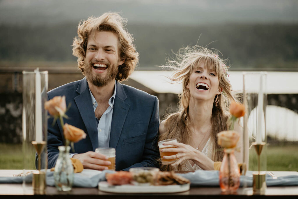 Bride and groom laugh during outdoor reception on Thunder Island