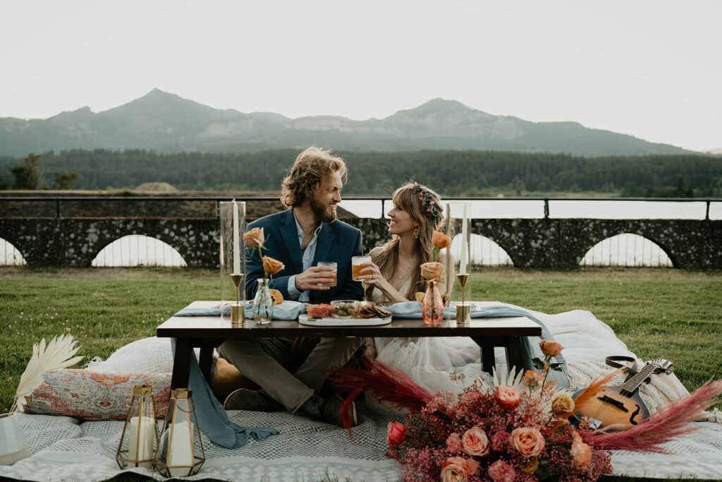 Bride and groom drinking during outdoor reception on Thunder Island