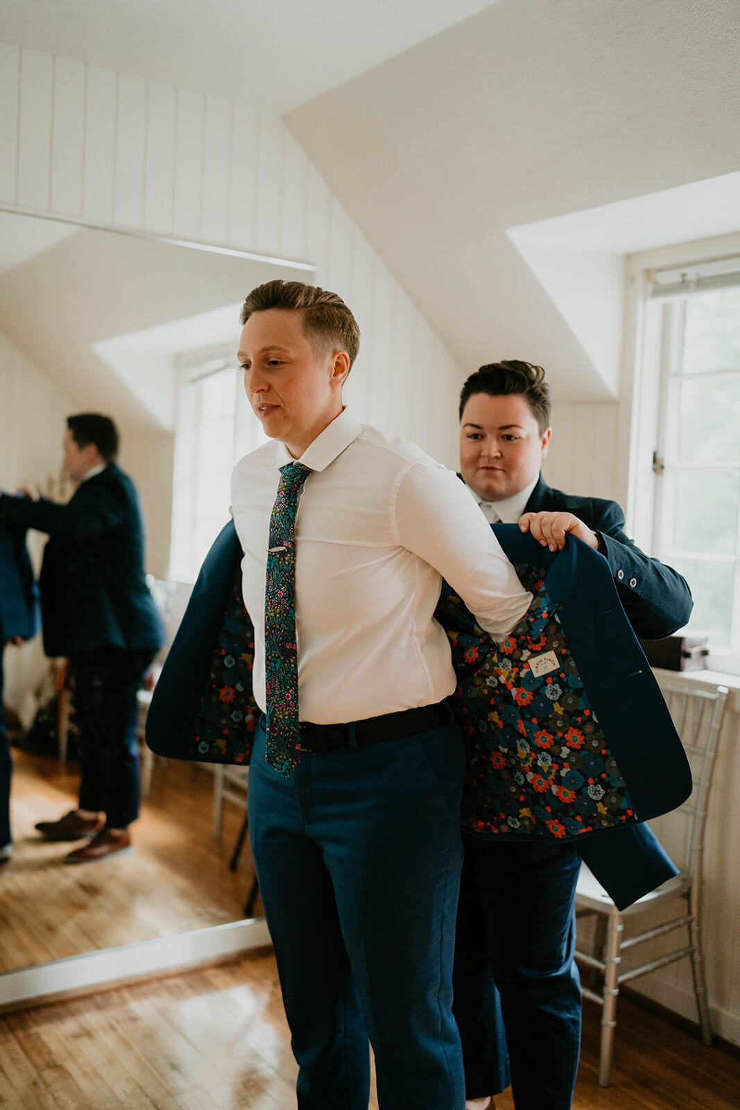 Bride putting on suit for botanical garden wedding