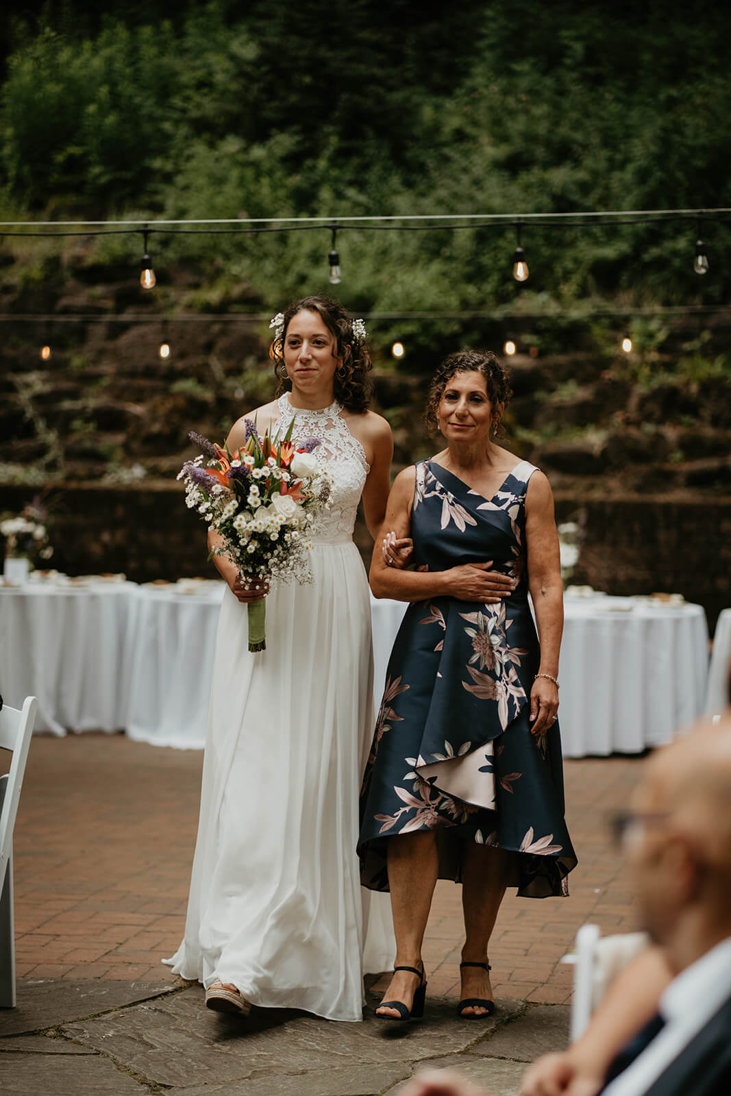 Bride walking down the aisle with mom