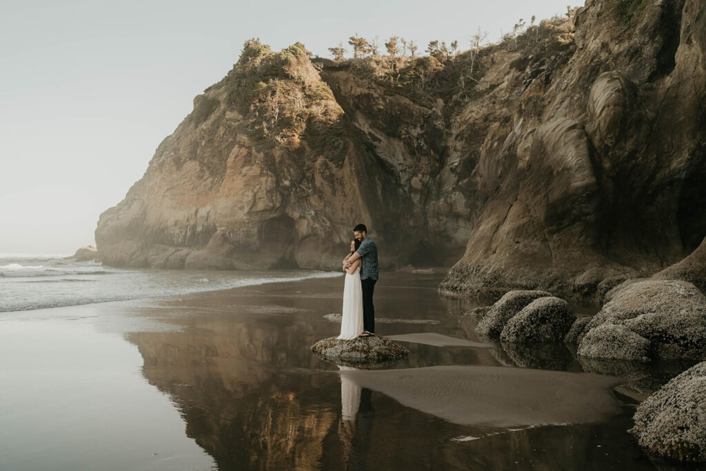 Bride and groom hug during Oregon Coast elopement