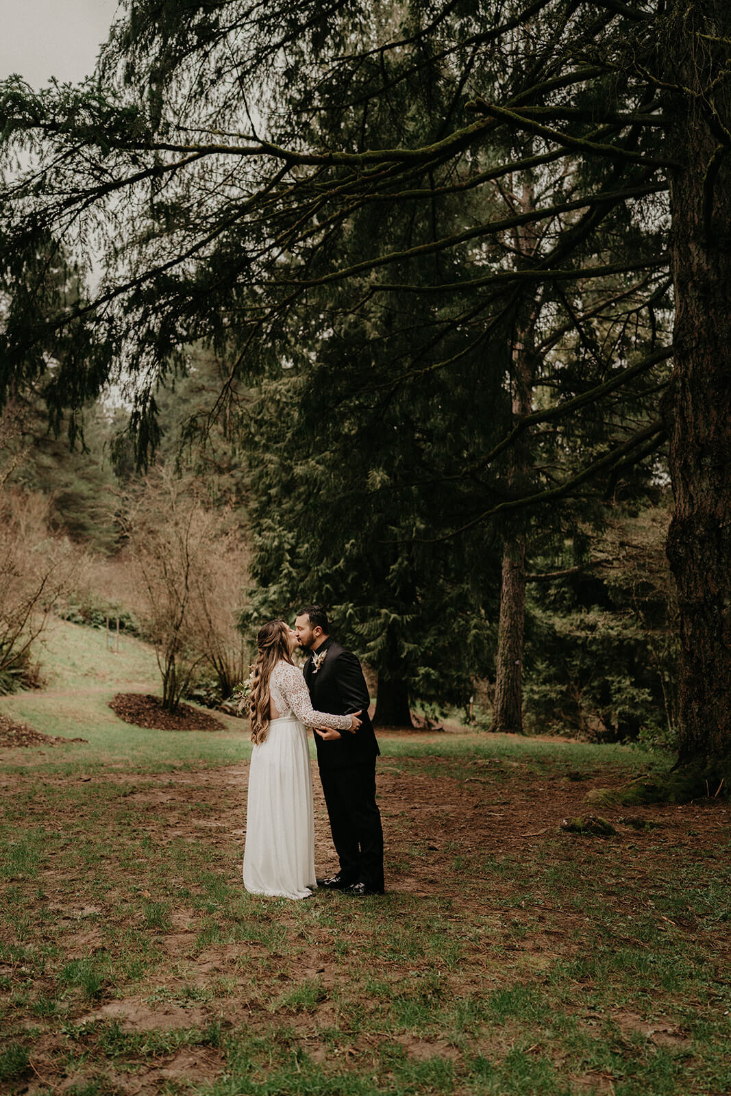 Bride and groom kiss after first loo in the forest