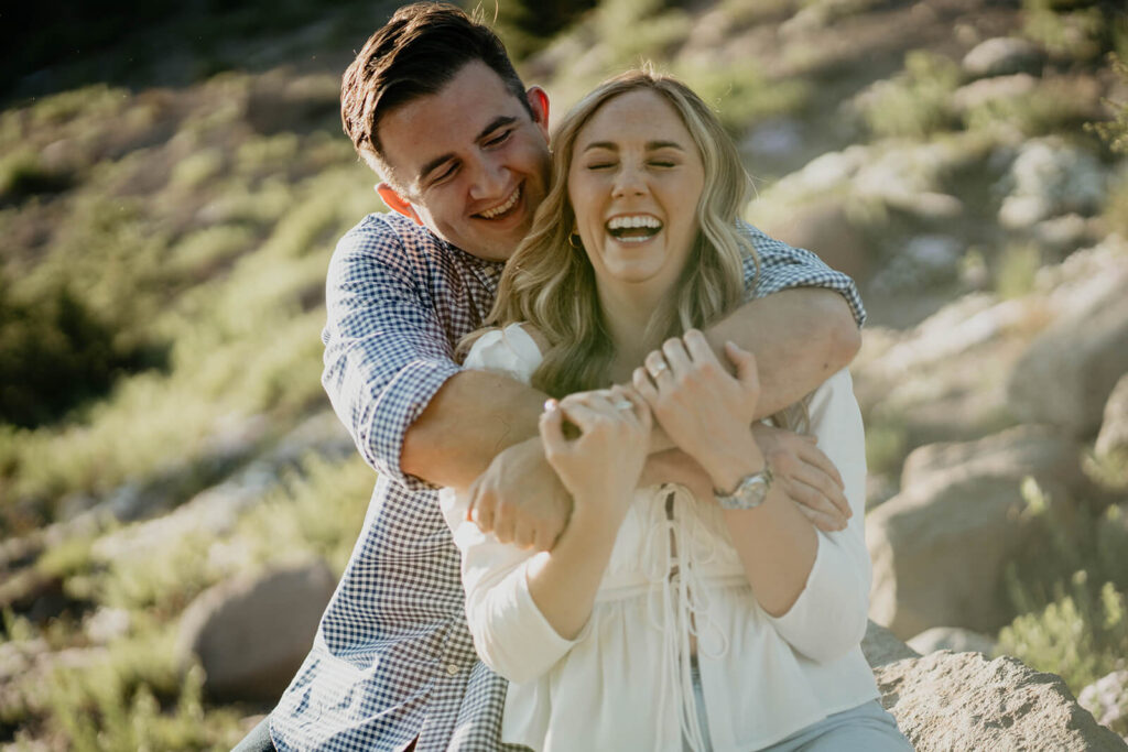 Couple laughing during engagement photo session at Mt Hood