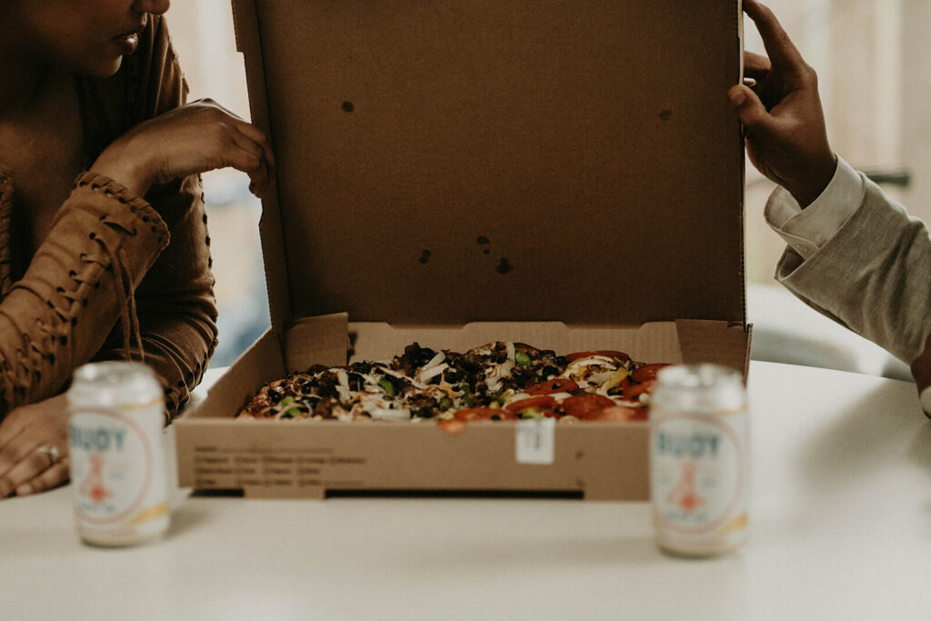 Bride and groom eating pizza at their Oregon coast elopement