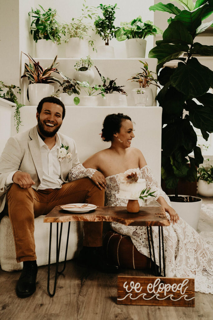 Bride and groom laughing and eating wedding cake at their Oregon coast elopement