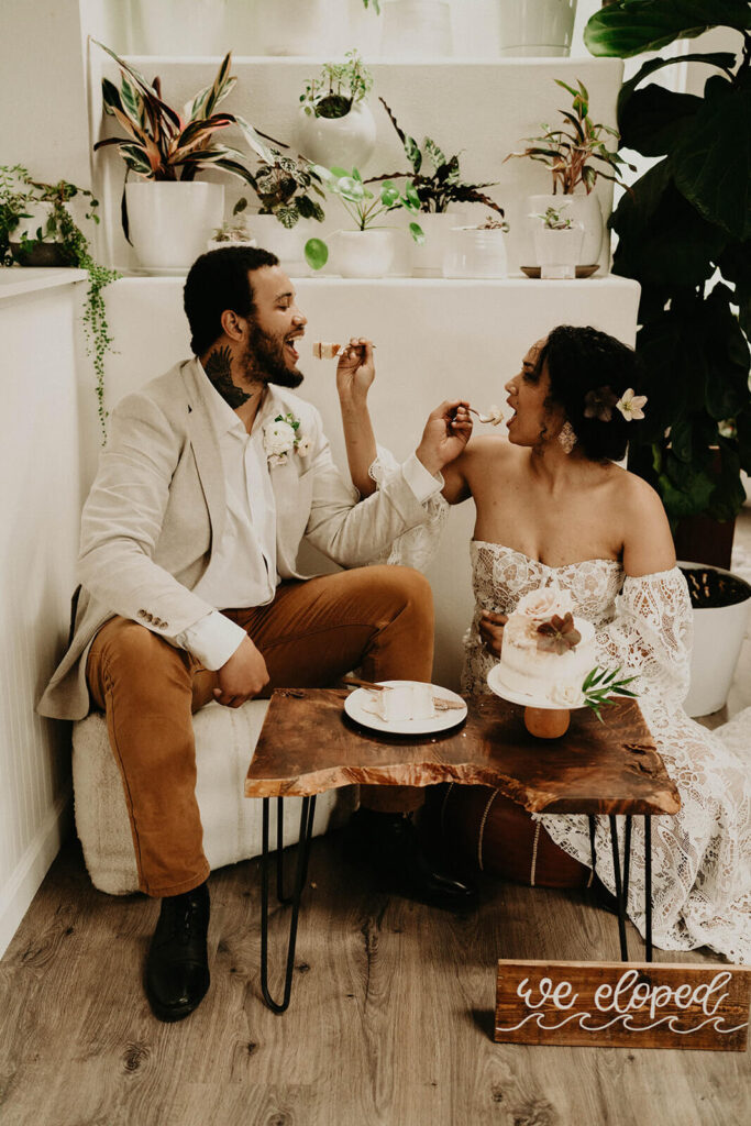 Bride and groom feeding each other wedding cake for their Oregon elopement