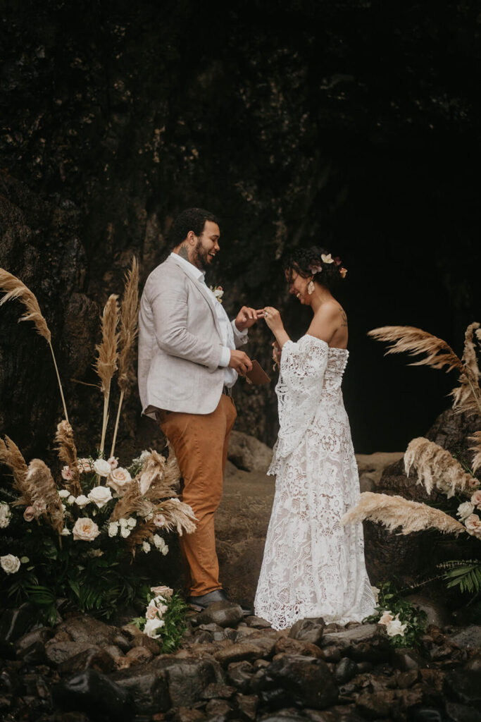 Bride and groom exchanging rings during Oregon coast elopement