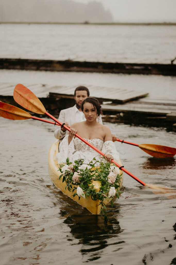 Bride and groom kayaking during their Oregon Coast elopement