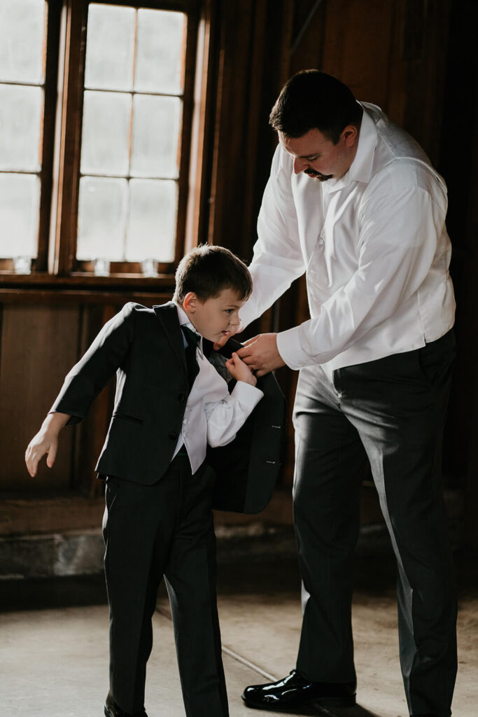 Groom helping son get ready for Oregon wedding