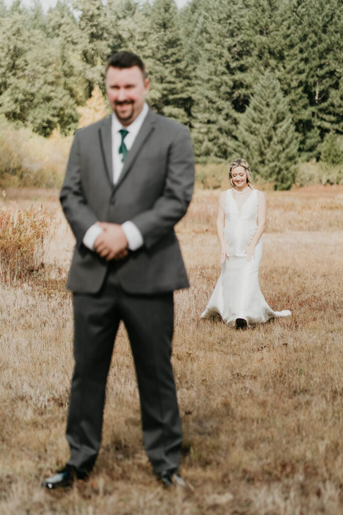 Bride and groom first look in a field at Silver Falls