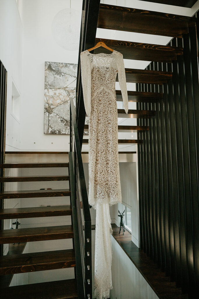 the bride's dress hanging from a staircase. 