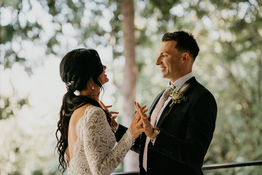 the bride and groom smiling and holding hands. 