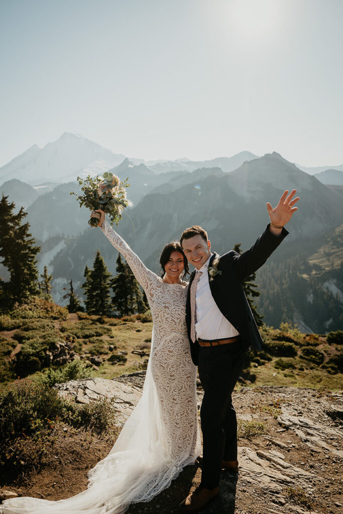 the newlyweds smiling with their arms up. 