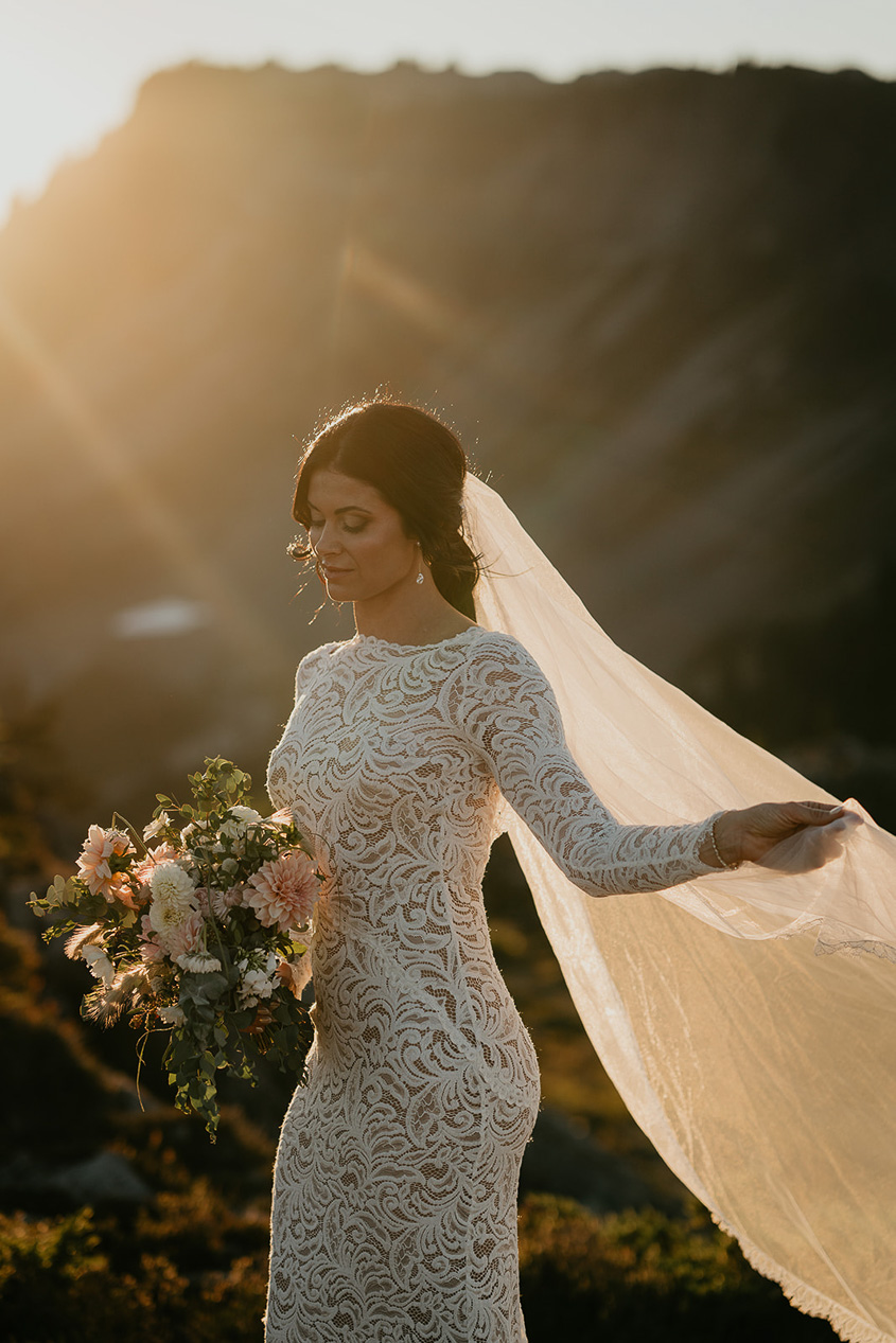 the bride showing off her veil at sunset during her North Cascades elopement. 