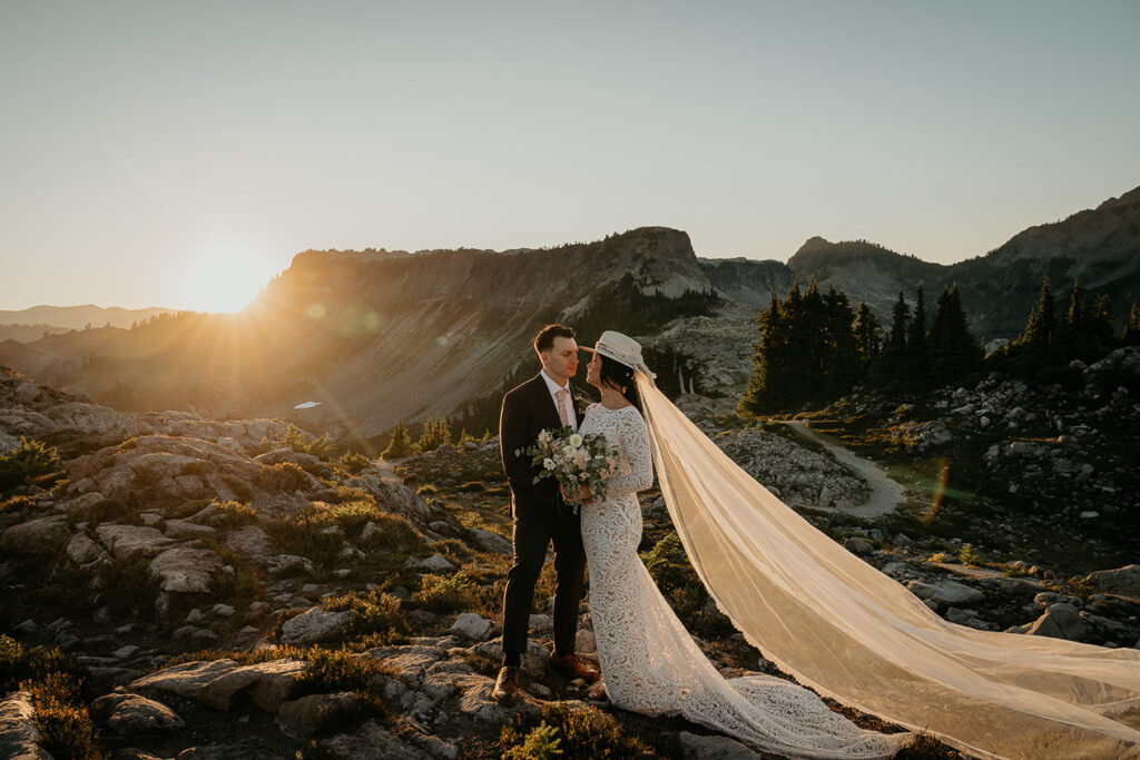 the bride and groom looking deeply into each other's eyes as the sun sets in the background. 