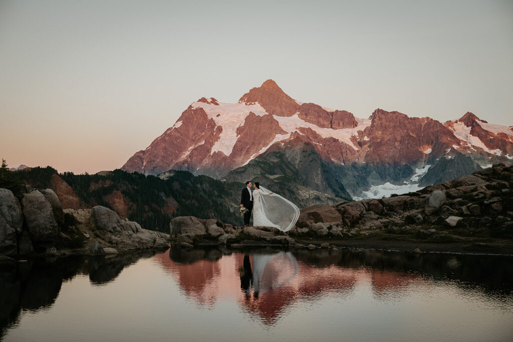 the newlyweds standing in front of a mountain in the North Cascades. 