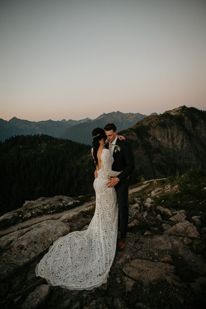 the newlyweds holding each other as the sun sets on their North Cascades elopement. 