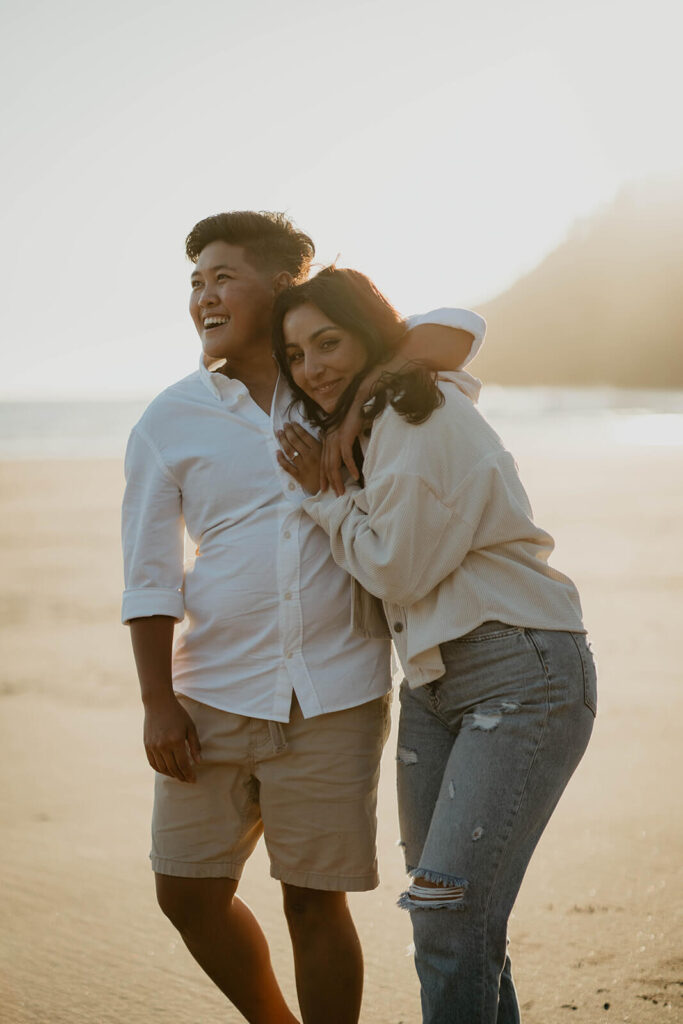 Two women hugging on the Oregon Coast for engagement photos