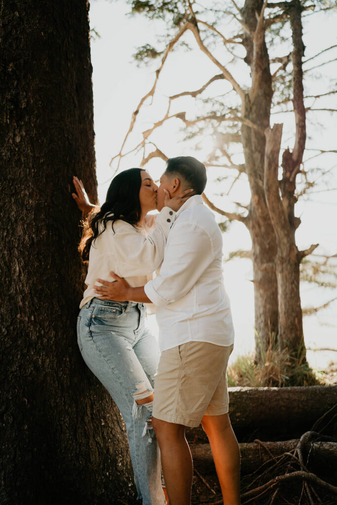 Two women kissing during engagement session on the Oregon coast