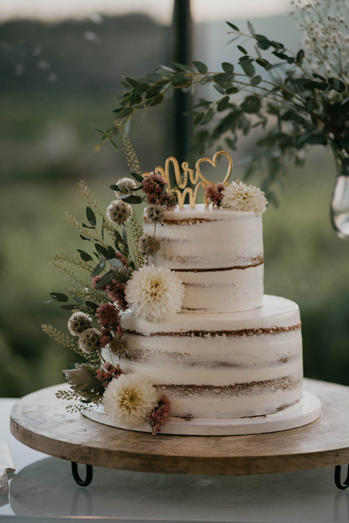 White wedding cake with white and red florals