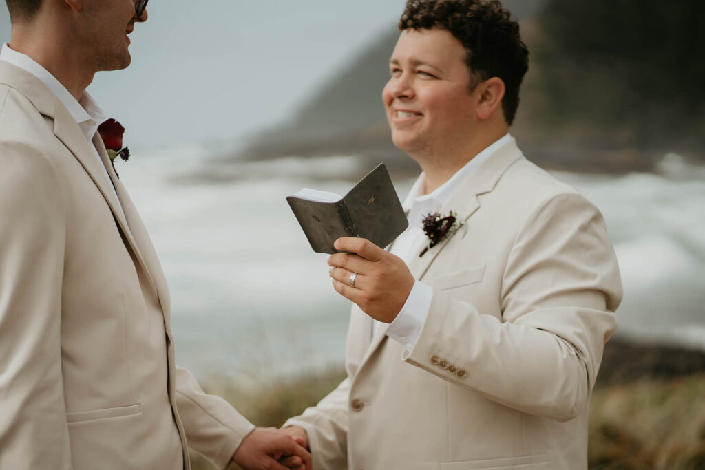 Groom reading wedding vows at outdoor elopement in Oregon