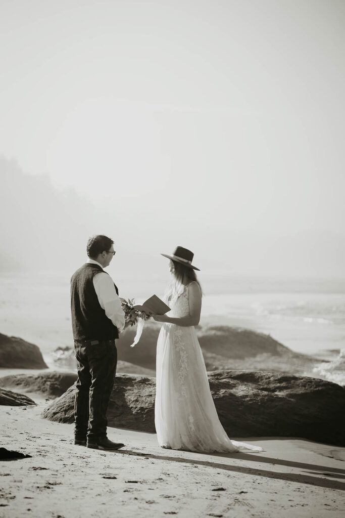 Bride and groom exchange vows during intimate beach wedding ceremony