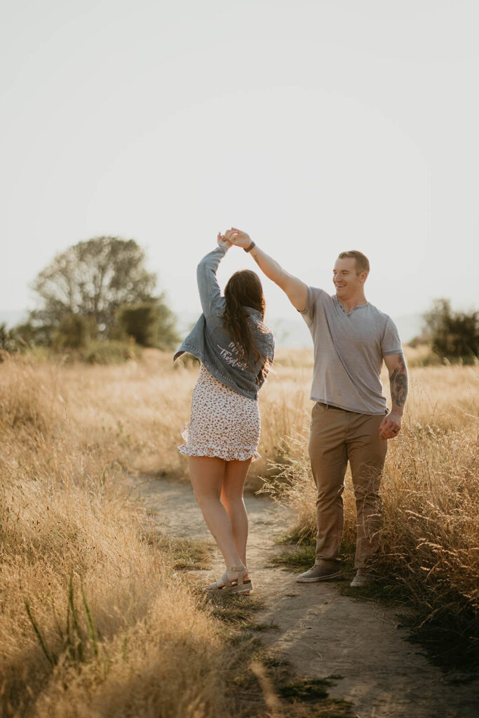 Couple dancing during their engagement photo session at Discovery Park