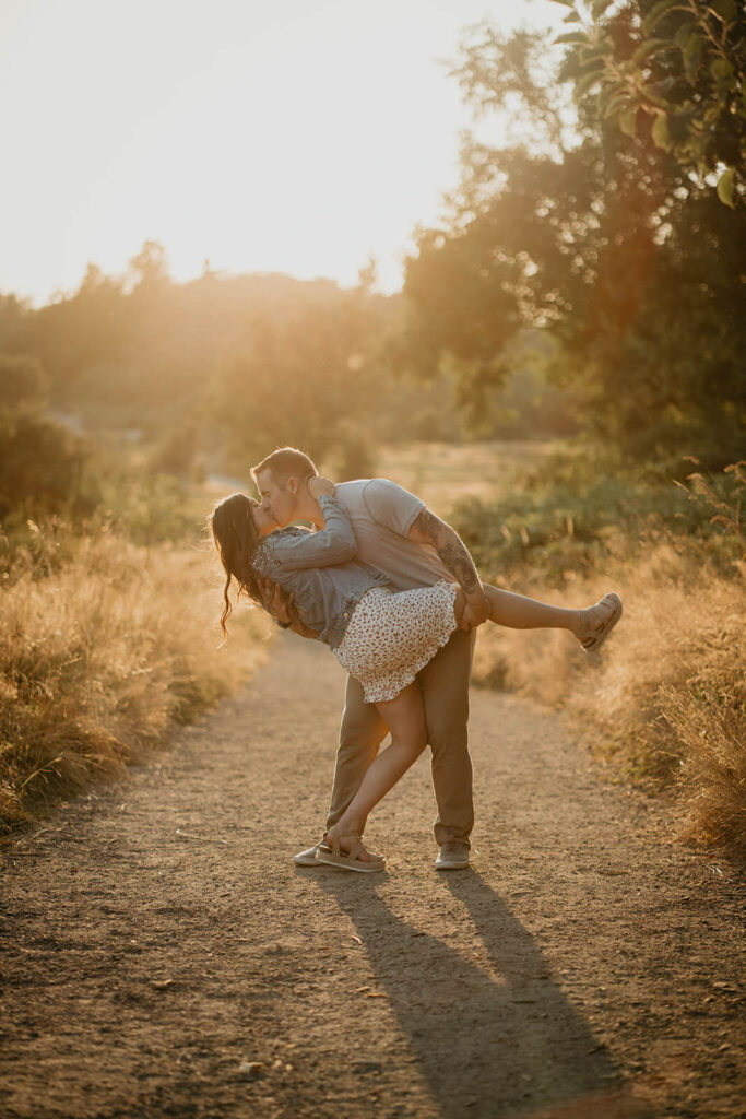 Couple kissing during sunset portraits  in Discovery Park