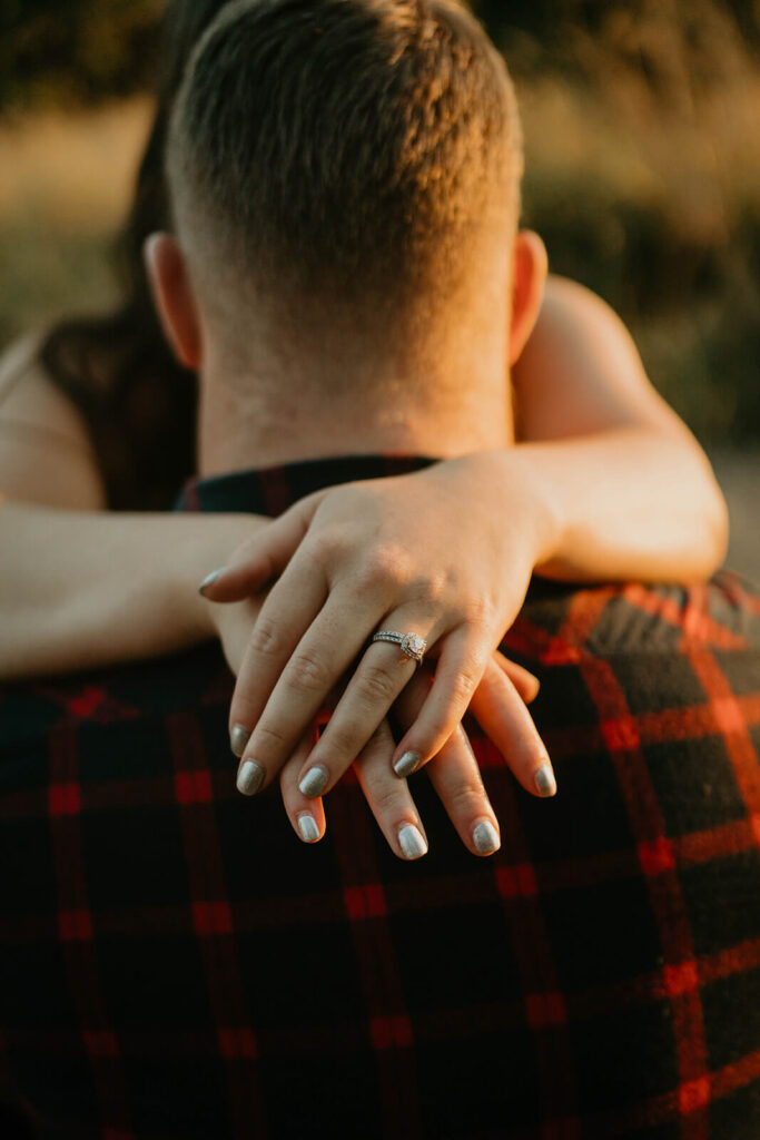 Woman wrapping arms around fiancee's neck during Seattle engagement photo session