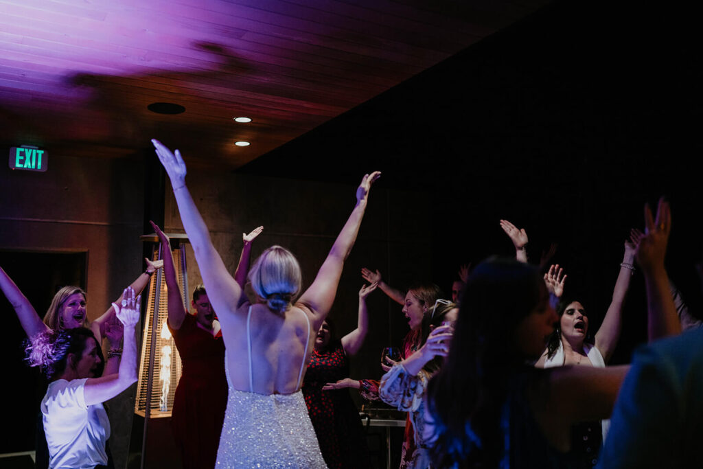 Wedding guests cheer on the dance floor at Oregon vineyard wedding