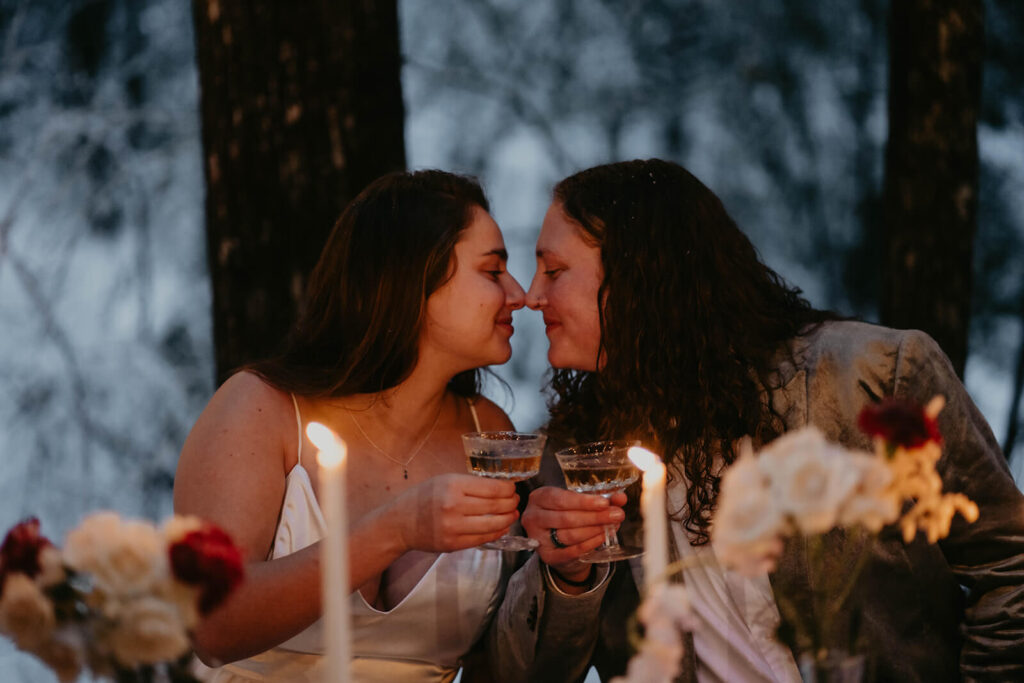 Dark moody wedding reception table at cozy Christmas cabin