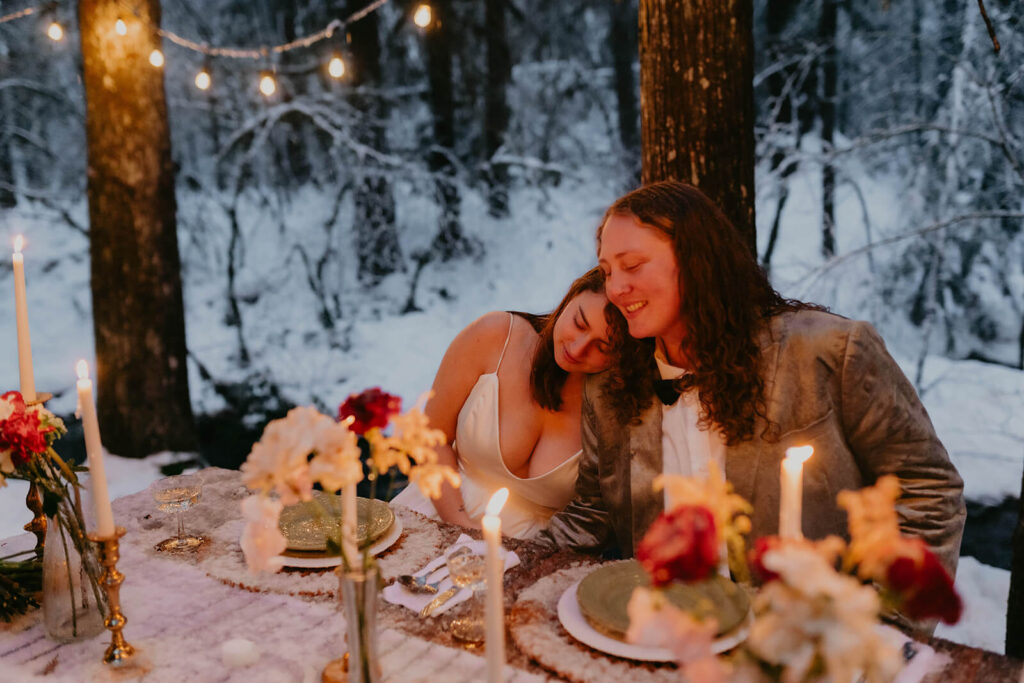 Dark moody wedding reception table at cozy Christmas cabin