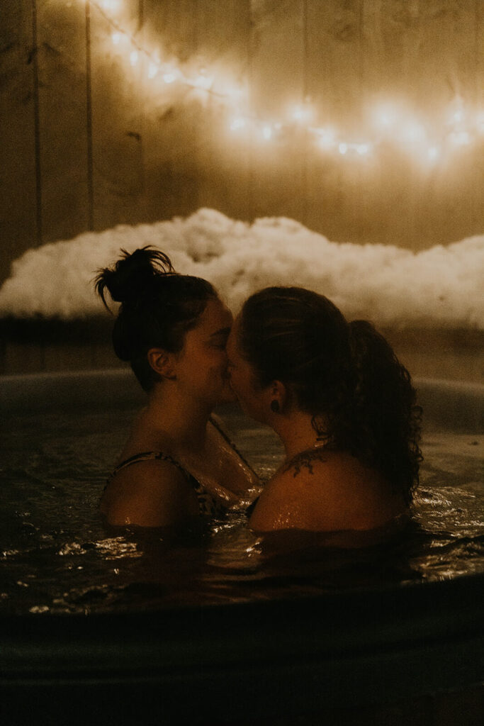 Dark moody wedding portraits in snowy hot tub