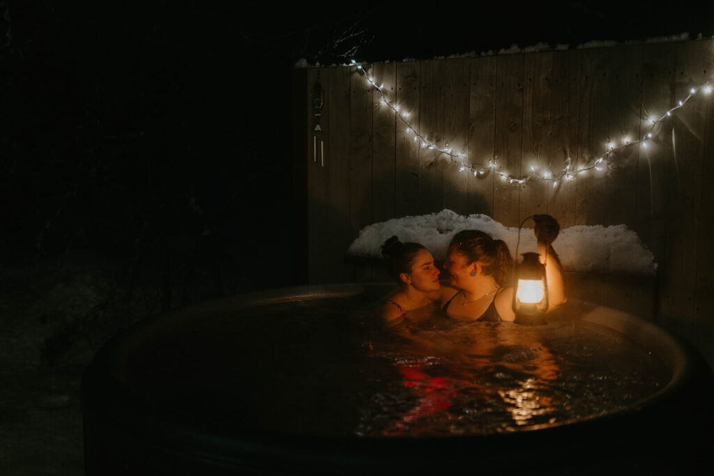 Dark moody wedding portraits in snowy hot tub