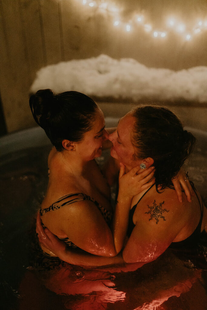 Dark moody wedding portraits in snowy hot tub