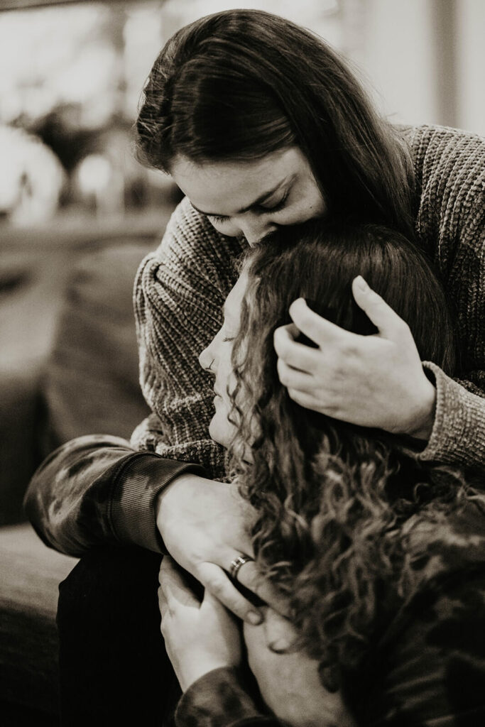 Two women kissing during their winter wonderland cabin elopement in Oregon