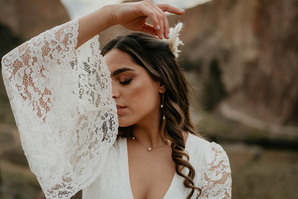 Bride wearing boho wedding dress with lace sleeves