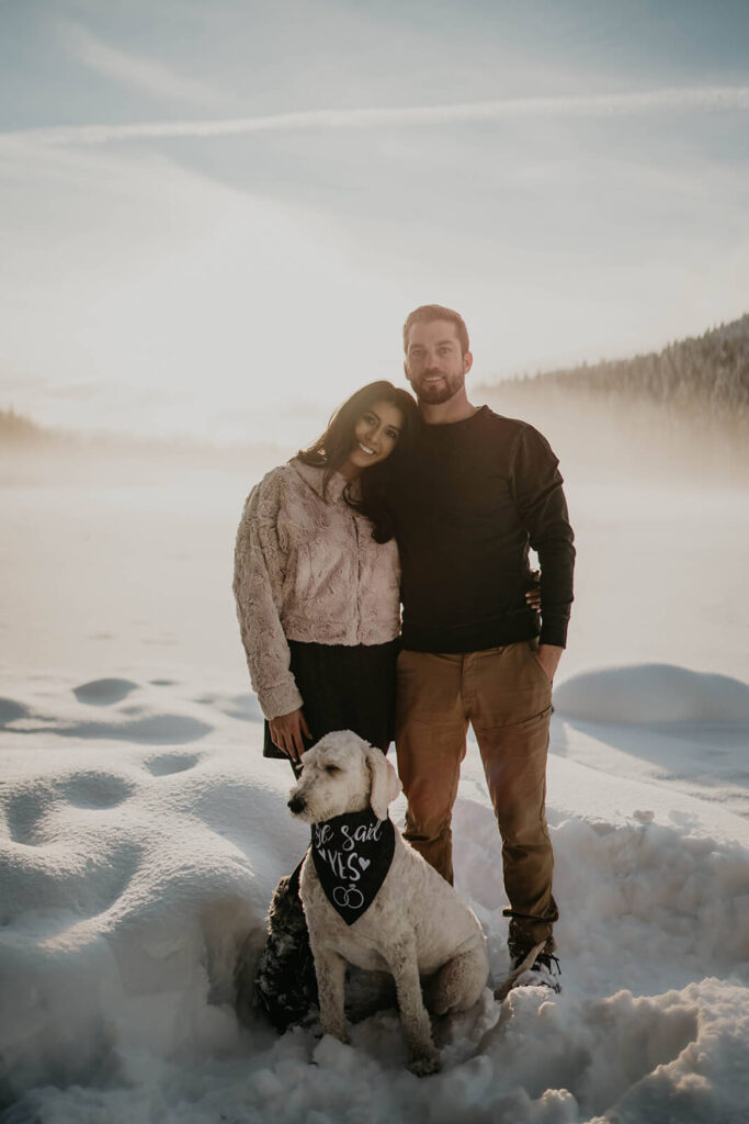 Couple hugging during snow engagement photos at Trillium Lake