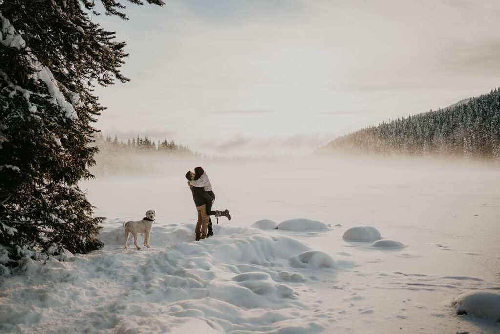 Couple kissing in the snow during winter engagement session