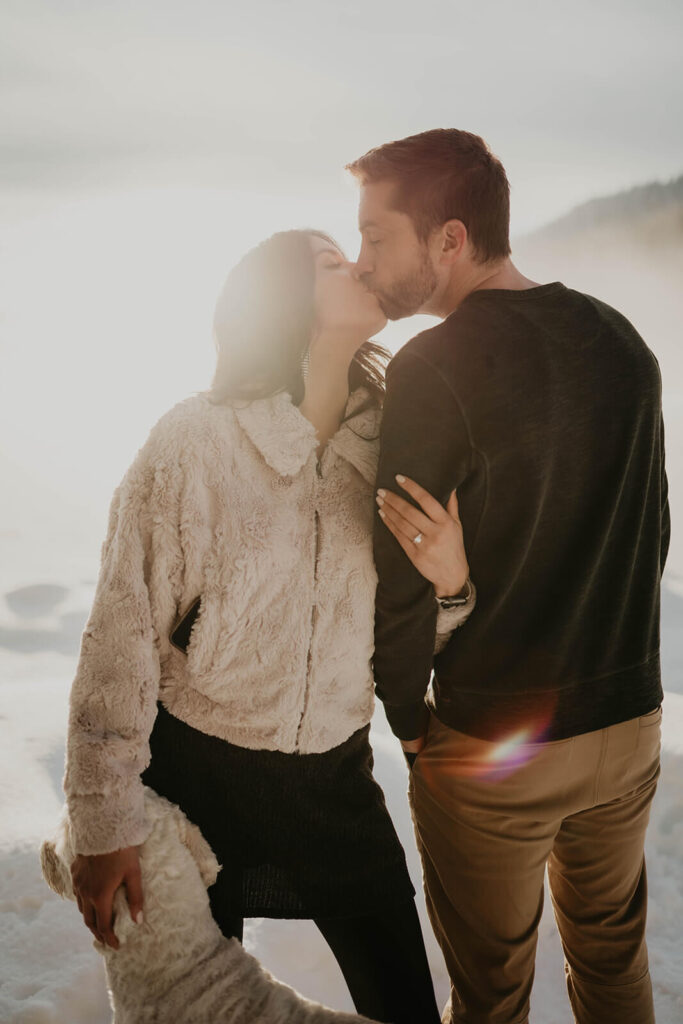 Couple kissing in the snow during winter engagement session at Mount Hood