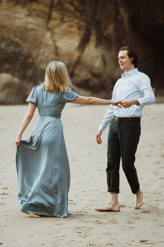 Couple dancing on the beach at Hug Point during engagement session