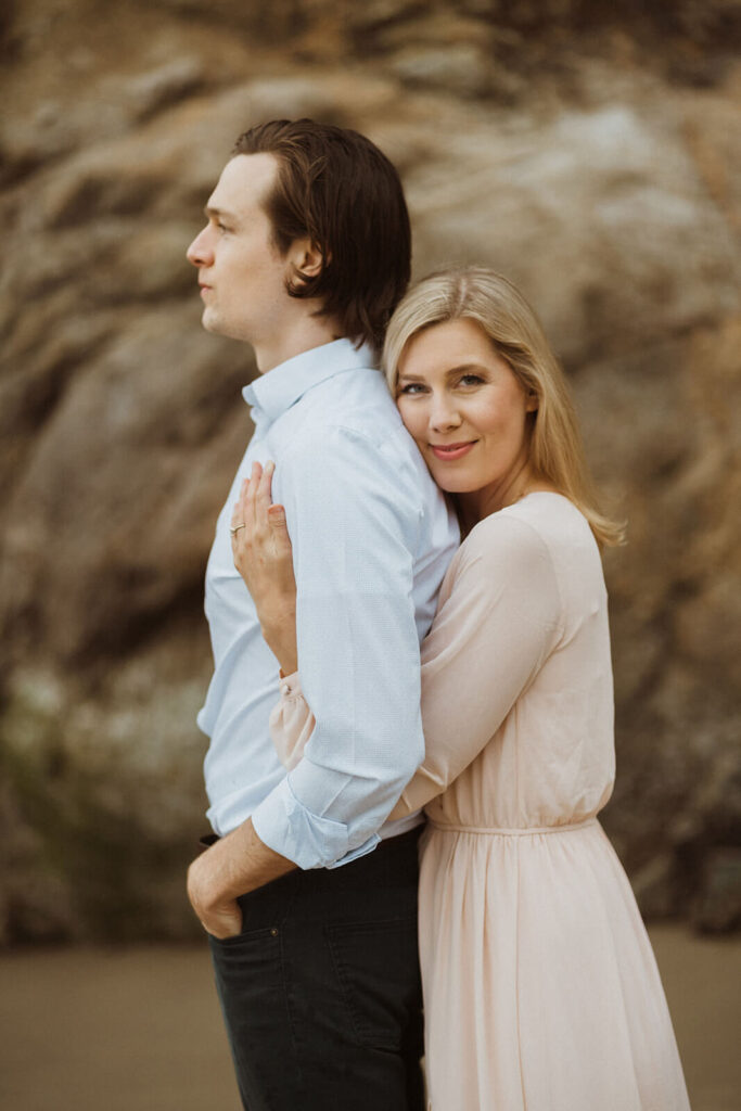 Couple hugging during engagement session at Hug Point