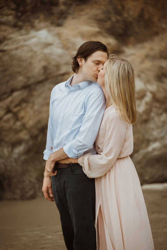 Couple kissing during engagement session at Hug Point