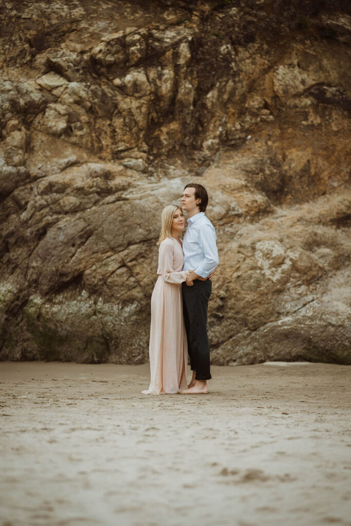 Couple hugging during engagement session at Hug Point