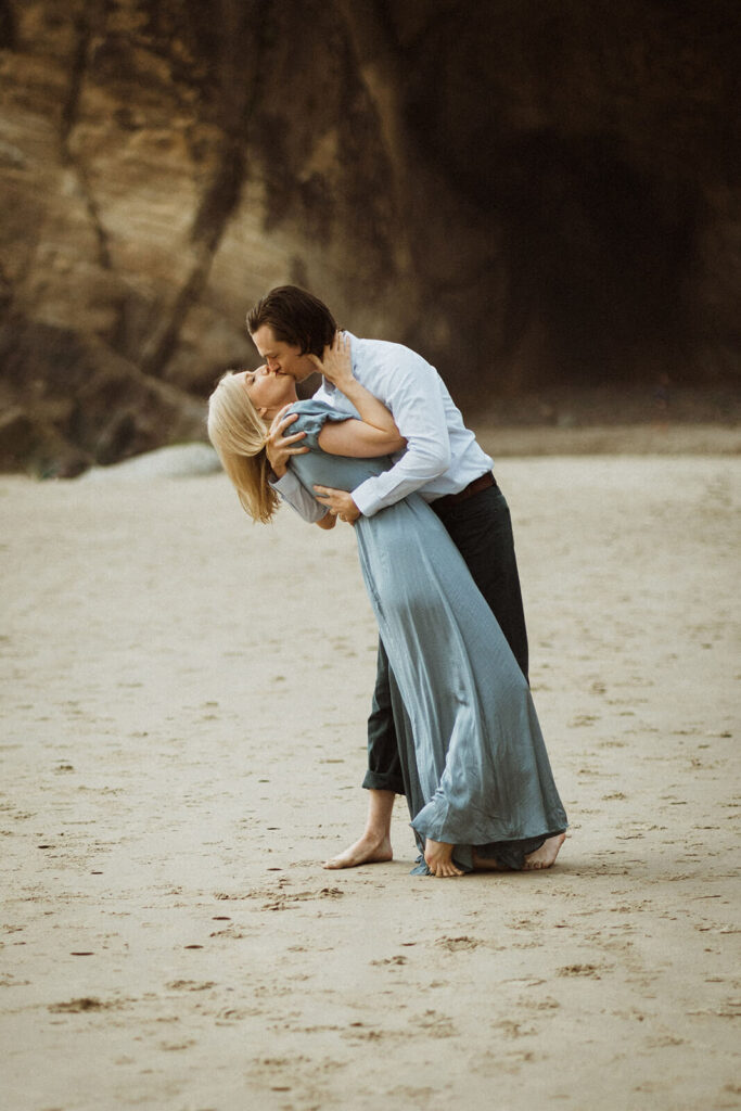 Couple kissing on the beach at Hug Point during engagement session